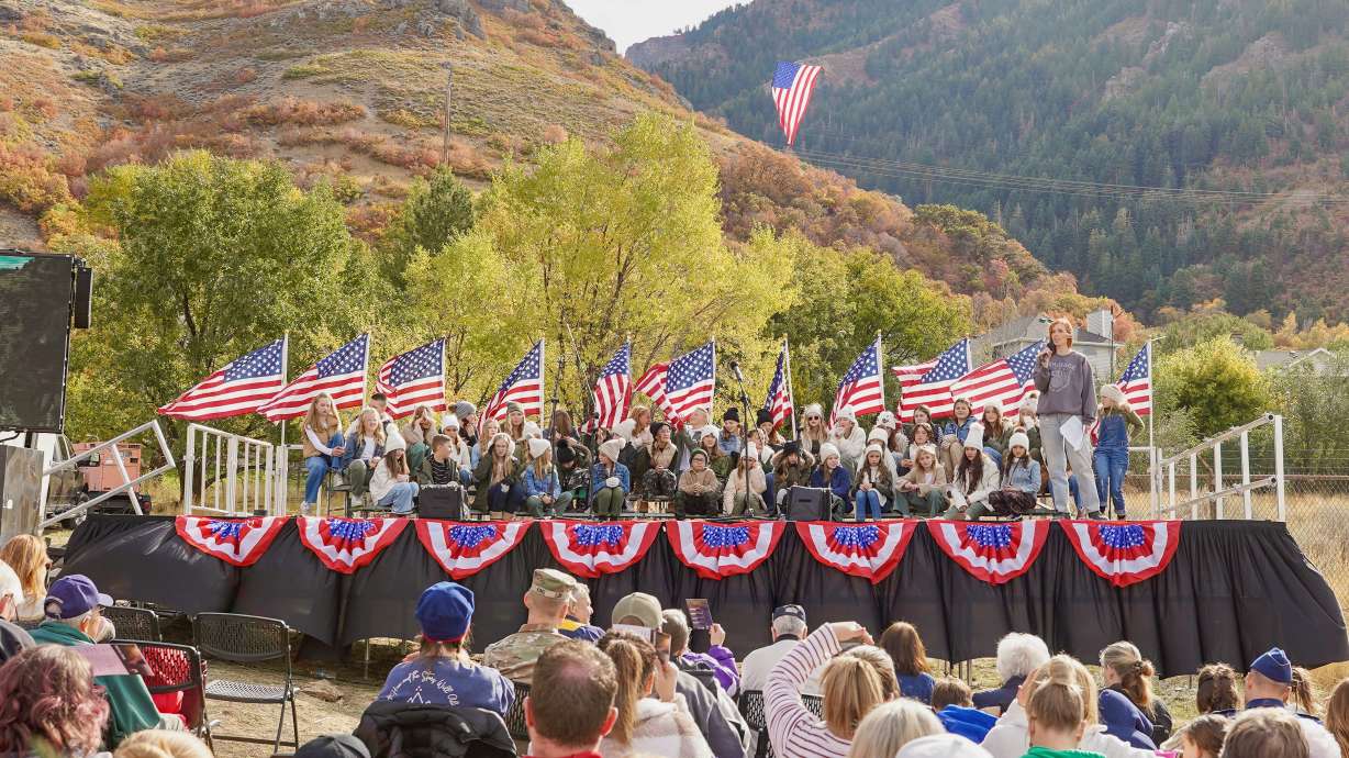 Jennie Taylor speaks at a gathering in North Ogden on Saturday to mark the unfurling of a giant U.S. flag across Coldwater Canyon and the start of Veterans Week activities.