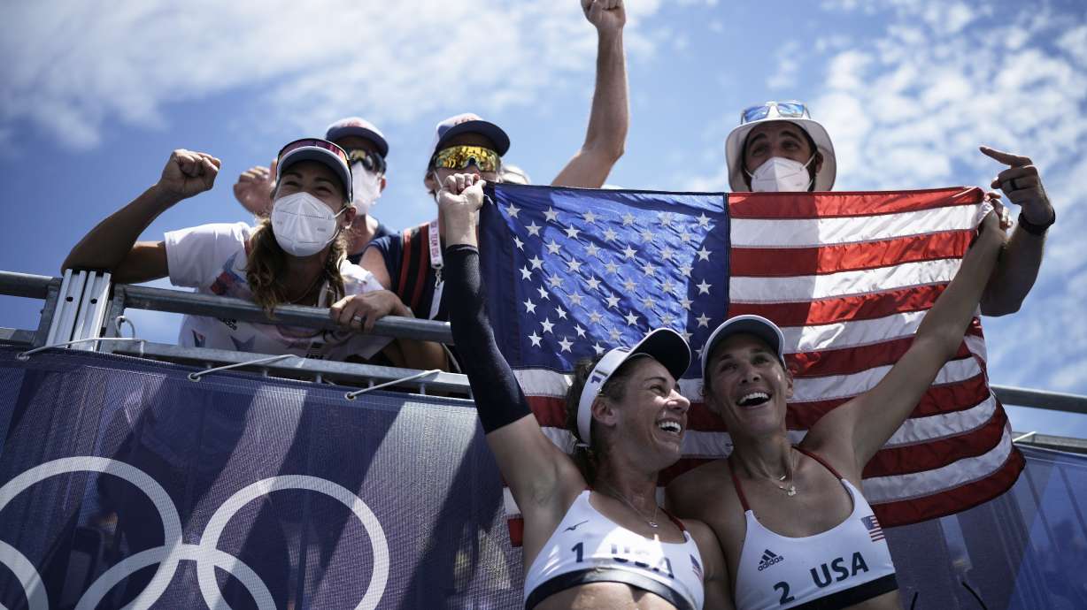 FILE - April Ross, bottom left, of the United States, and teammate Alix Klineman, bottom right, celebrate after winning a women's beach volleyball gold medal match against Australia at the 2020 Summer Olympics, Aug. 6, 2021, in Tokyo, Japan.