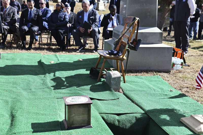 An urn contains the cremated remains of Byron R. Johnson, a Union soldier who was born in Pawtucket, Rhode Island, in 1844 and fought in the Civil War, rests at his burial site during funeral services, Oct. 16, at Oak Grove Cemetery, in Pawtucket.