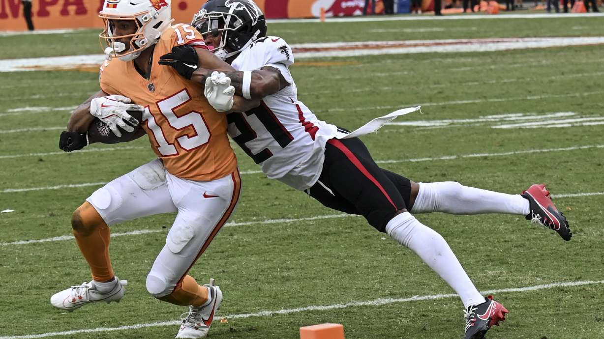 Atlanta Falcons safety Richie Grant (27) hits Tampa Bay Buccaneers wide receiver Jalen McMillan (15) during the second half of an NFL football game, Sunday, Oct. 27, 2024, in Tampa.