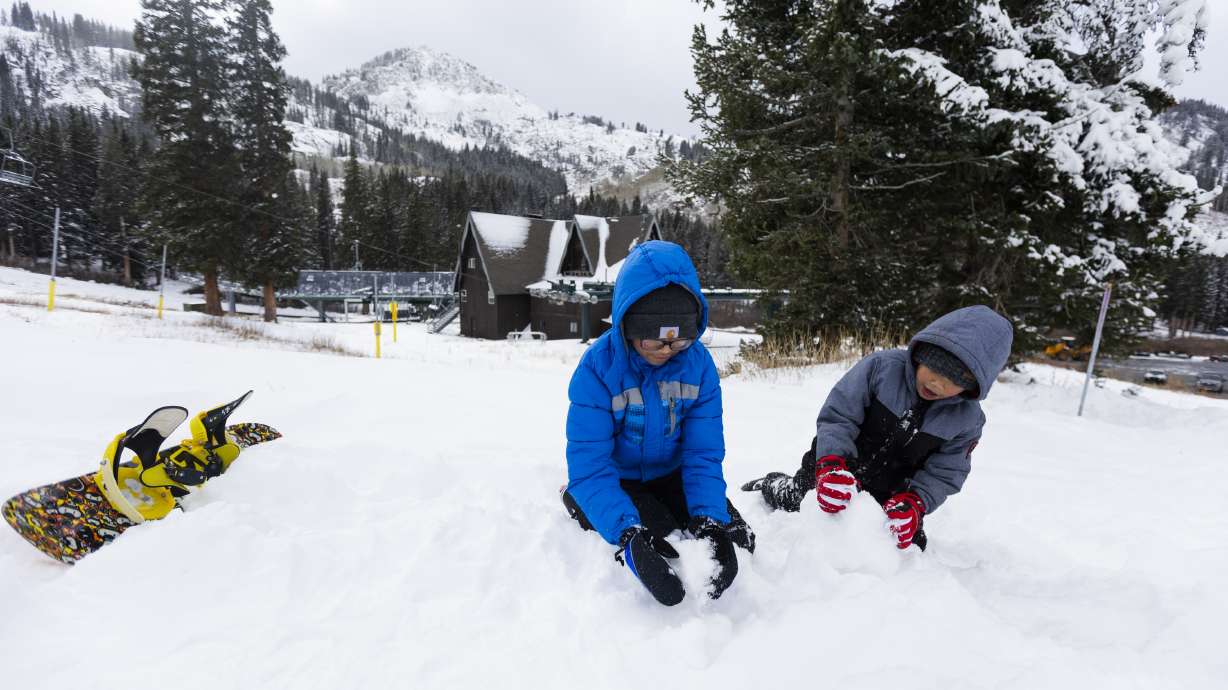 Cousins Janiyah Obiles, 12, on the left, and Rider Garland, 5, on the right, play in new snow at Brighton Resort in Big Cottonwood Canyon on Sunday. A small storm is expected to arrive on Tuesday.