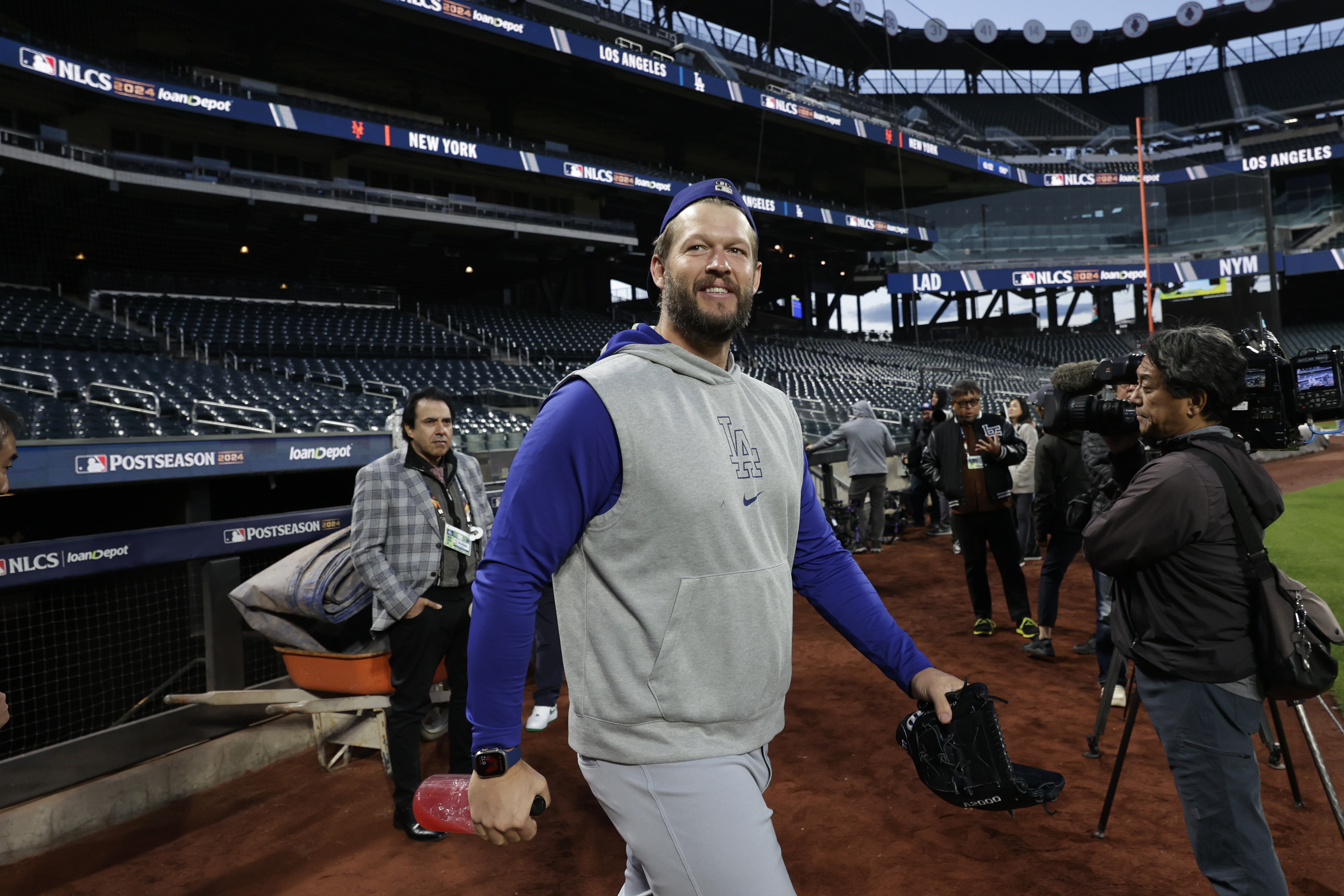 Los Angeles Dodgers pitcher Clayton Kershaw walks onto the field for a team workout Tuesday, Oct. 15, 2024, in New York ahead of Game 3 of the baseball NL Championship Series against the New York Mets.