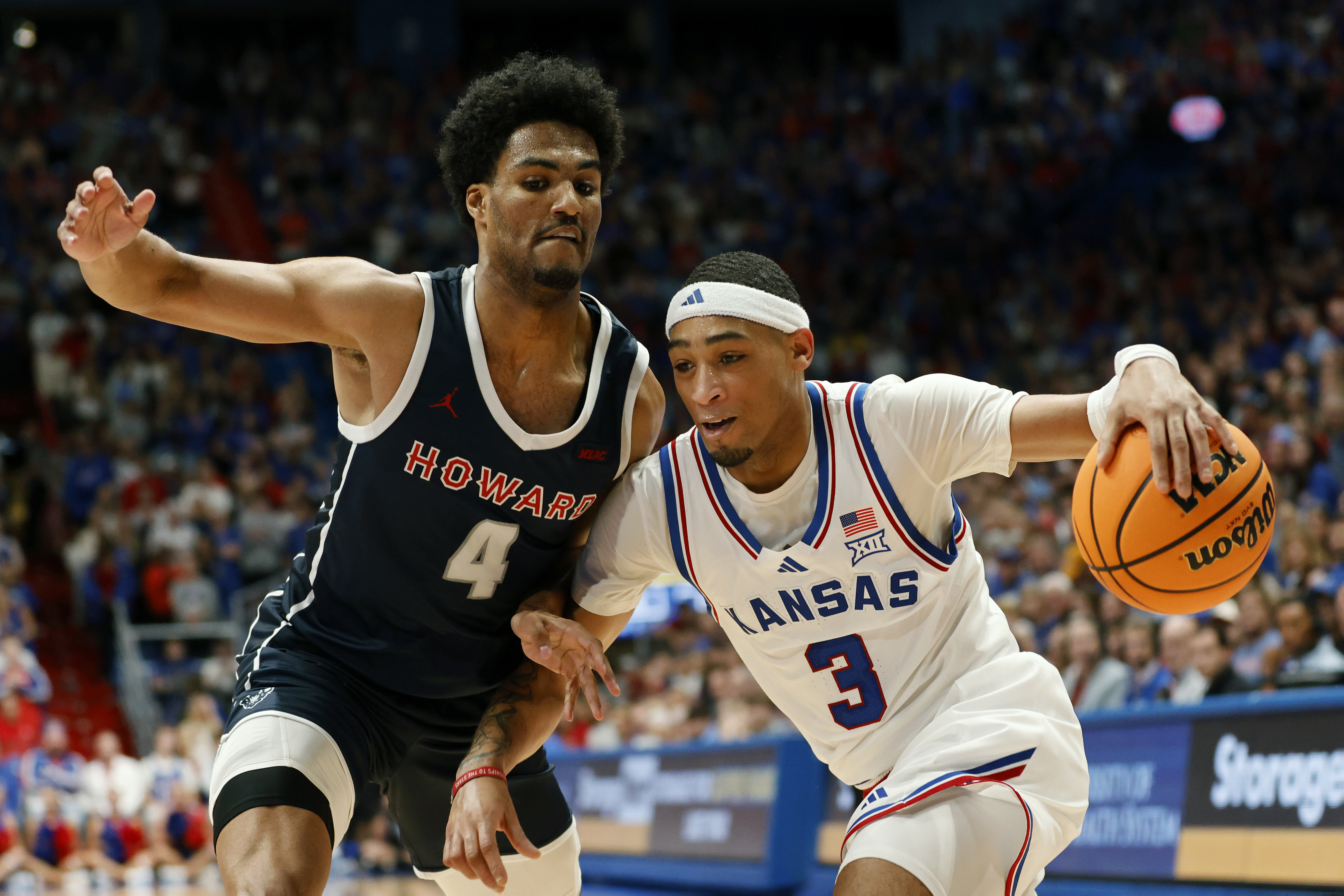 Kansas guard Dajuan Harris Jr. (3) attempts to get past Howard forward Miles Stewart (4) during the first half of an NCAA college basketball game, Monday, Nov. 4, 2024, in Lawrence, Kan. 