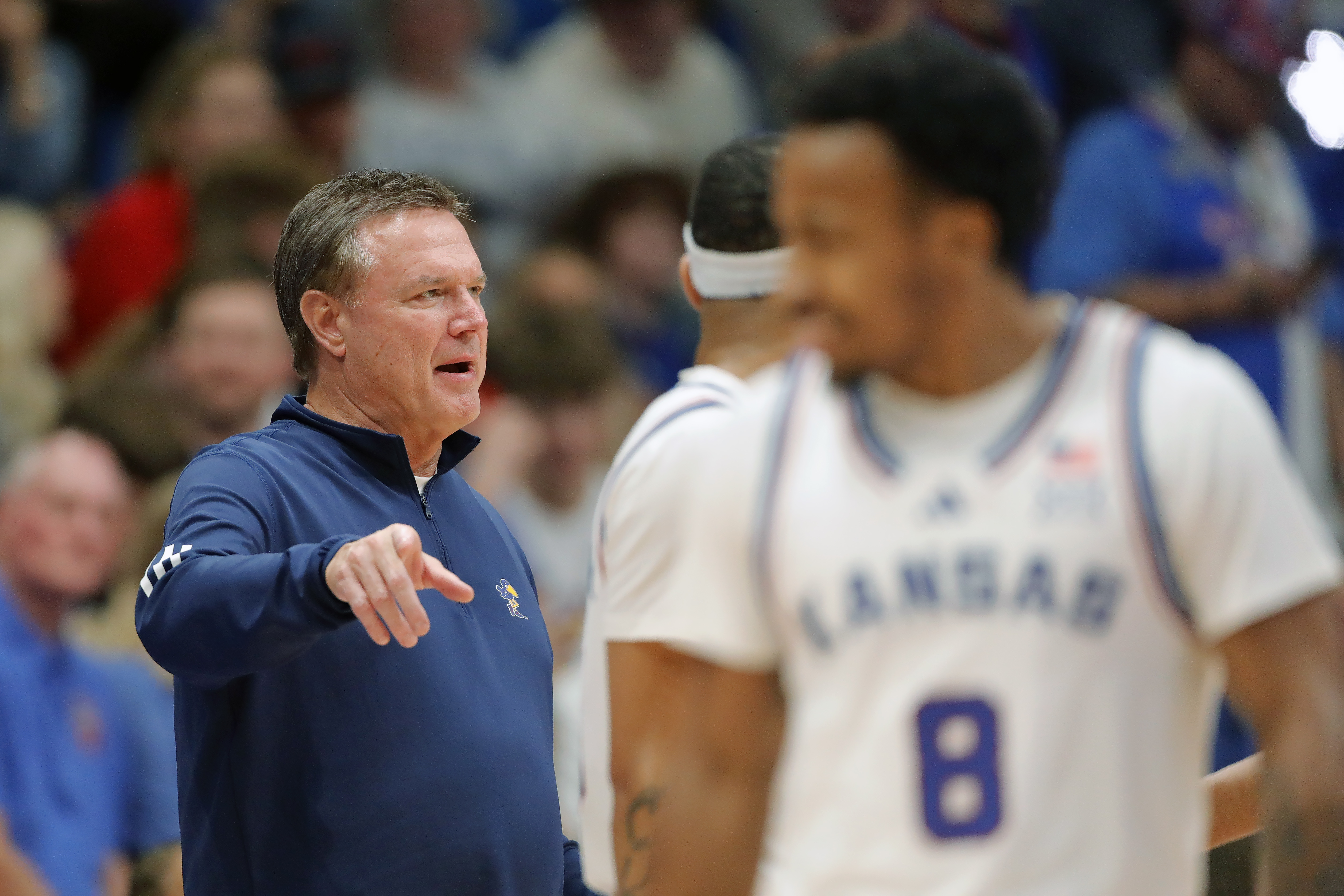 Kansas head coach Bill Self, left, speaks with his players during the second half of an NCAA college basketball game against Howard, Monday, Nov. 4, 2024, in Lawrence, Kan.