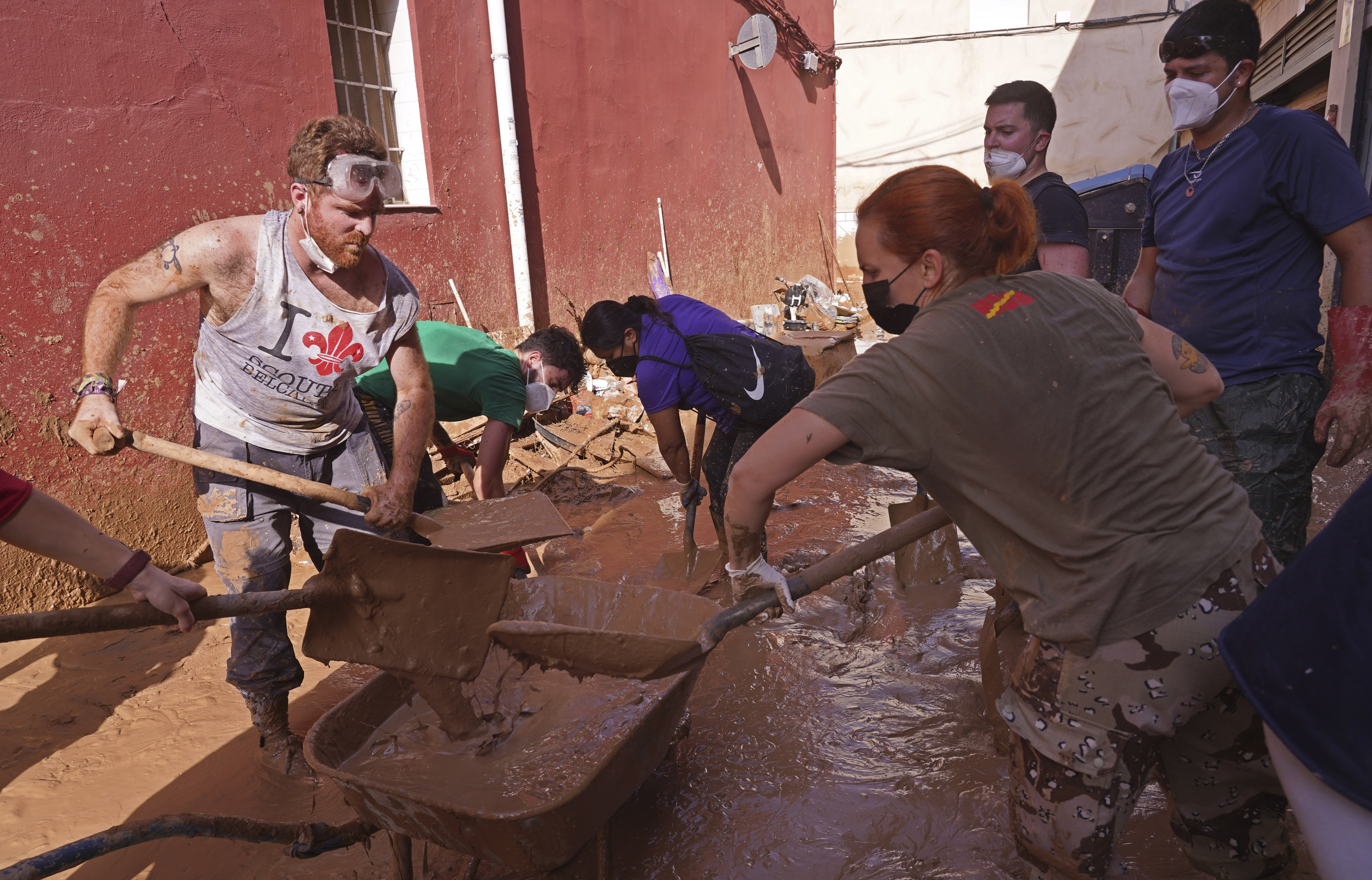 People shovel up mud after floods in Catarroja on the outskirts of Valencia, Spain, Tuesday, Nov. 5, 2024.
