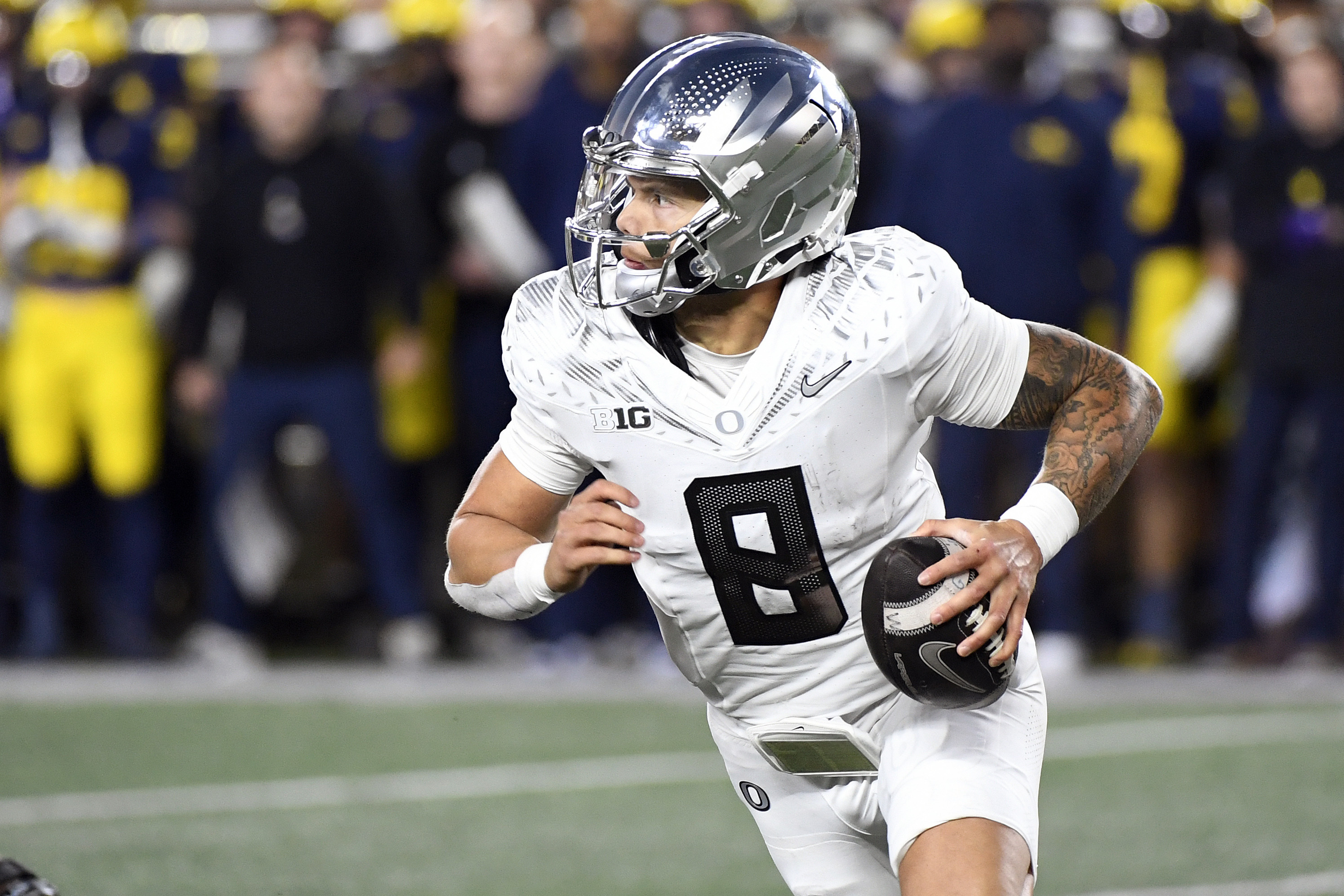 Oregon quarterback Dillon Gabriel scrambles out of the pocket against Michigan in the second half of an NCAA college football game, Saturday, Nov. 2, 2024, in Ann Arbor, Mich. Oregon defeated Michigan 38-17.