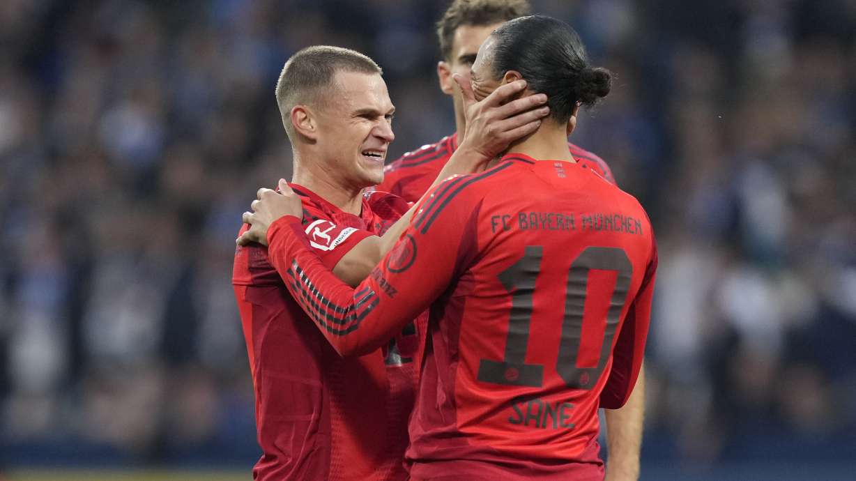 Joshua Kimmich, left, celebrates Leroy Sane, right, after he scored the 4th goal during the German Bundesliga soccer match between VfL Bochum and Bayern Munich in Bochum, Germany, Sunday, Oct. 27, 2024.