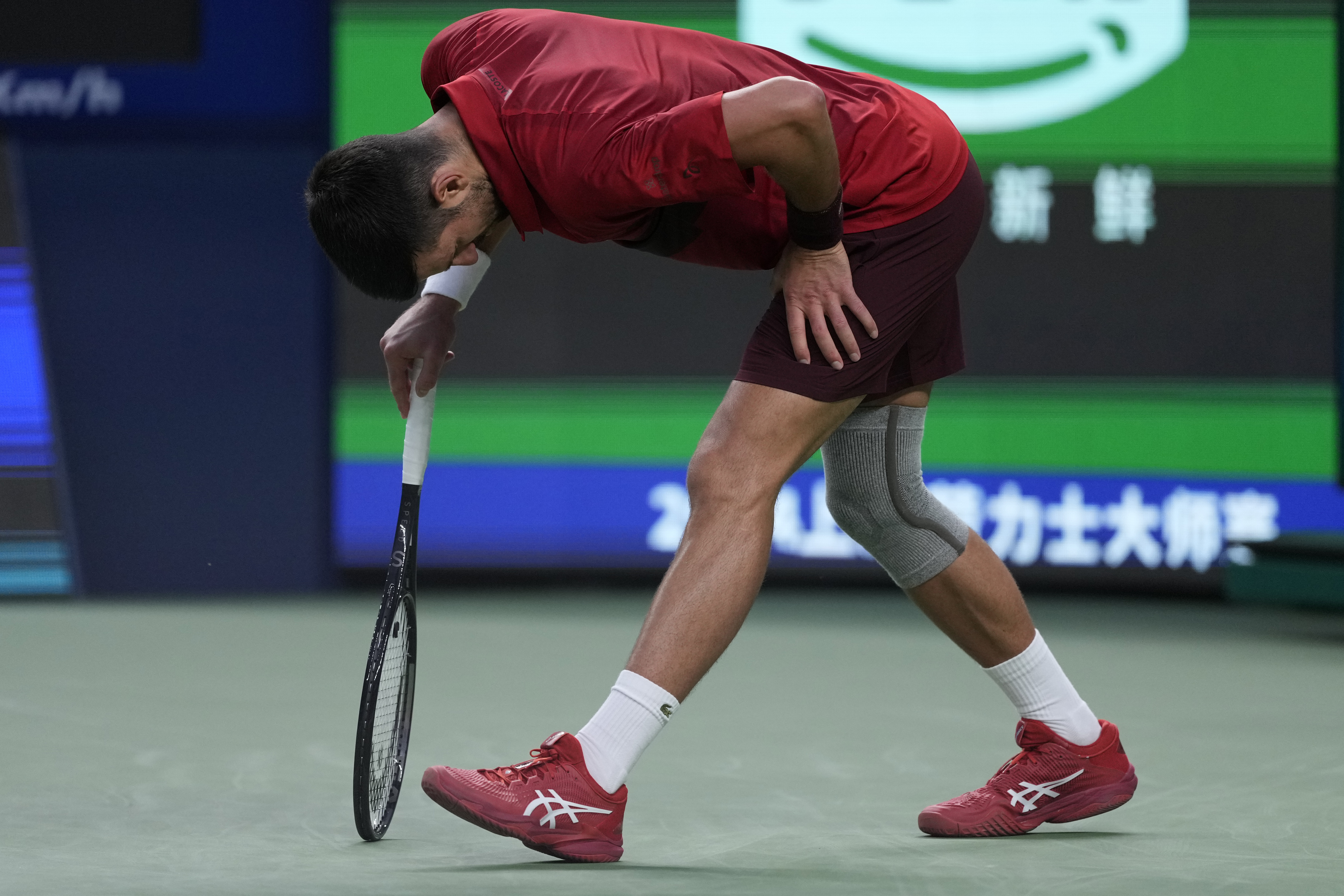 Novak Djokovic of Serbia reacts during the men's singles finals match against Jannik Sinner of Italy in the Shanghai Masters tennis tournament at Qizhong Forest Sports City Tennis Center in Shanghai, China, Sunday, Oct. 13, 2024.