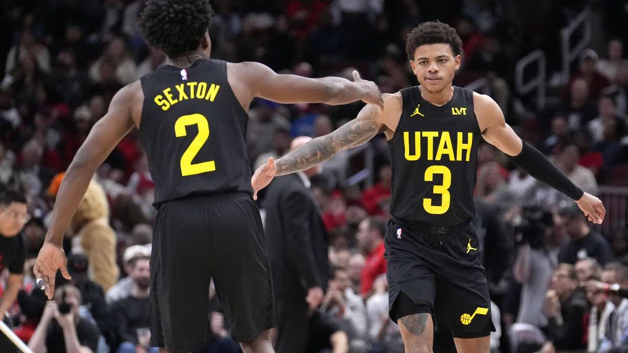Utah Jazz's Keyonte George (3) celebrates his three-point basket with Collin Sexton during the second half of an NBA basketball game against the Chicago Bulls on Monday, Nov. 4, 2024, in Chicago.