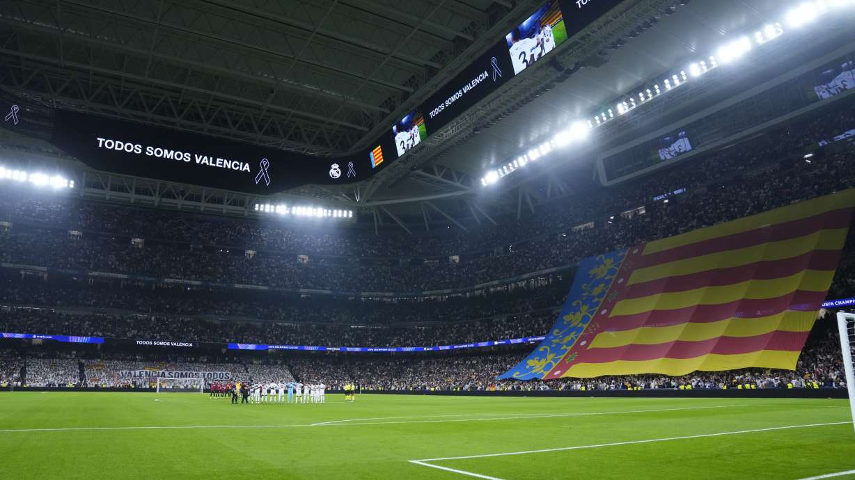 Players of Real Madrid and AC Milan observe a minute of silence for the victims of floods in Spain before the Champions League opening phase soccer match at the Santiago Bernabeu stadium in Madrid, Spain, Tuesday, Nov. 5, 2024.