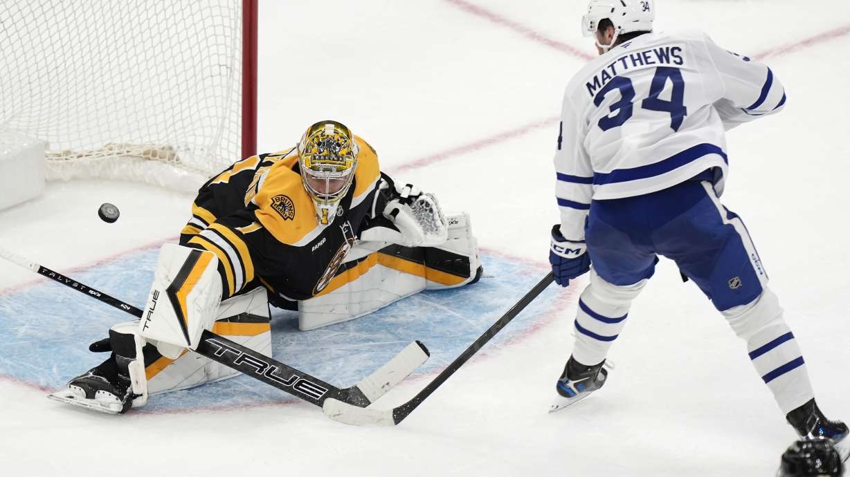 Toronto Maple Leafs' Auston Matthews (34) scores the game-tying goal on Boston Bruins' Jeremy Swayman (1) during the third period of an NHL hockey game, Saturday, Oct. 26, 2024, in Boston.