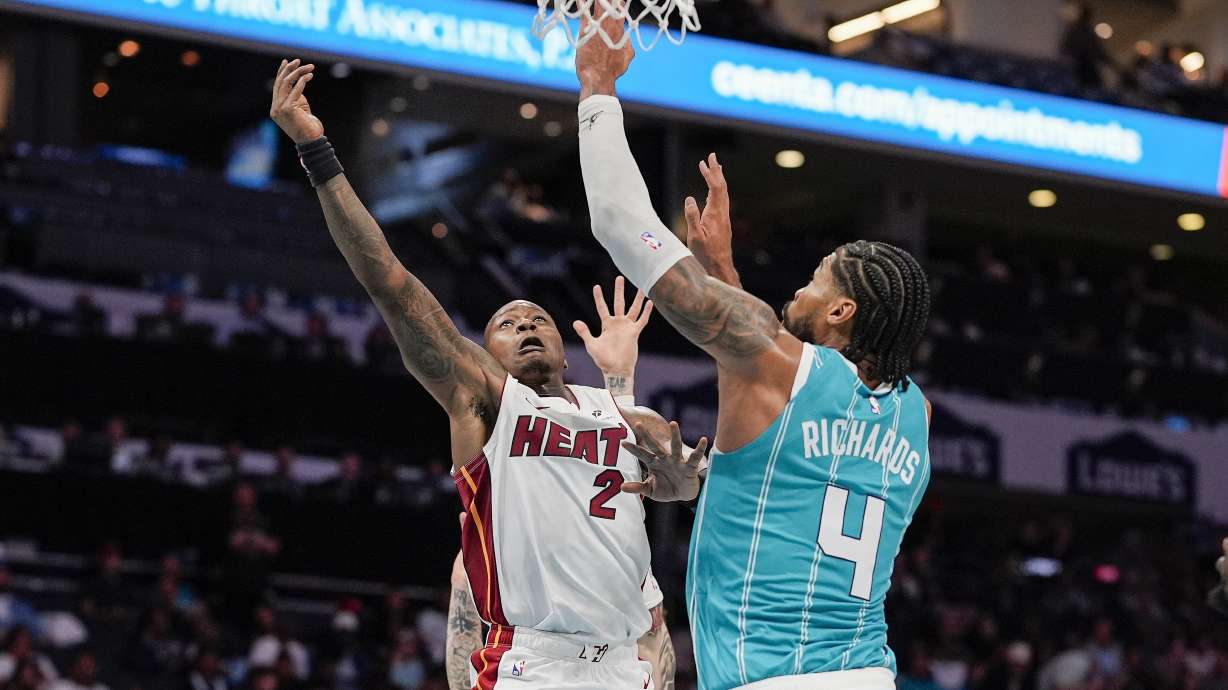 Miami Heat guard Terry Rozier (2) shoots the ball defended by Charlotte Hornets center Nick Richards (4) during the second half of an NBA basketball game in Charlotte, N.C., Saturday, Oct. 26, 2024.