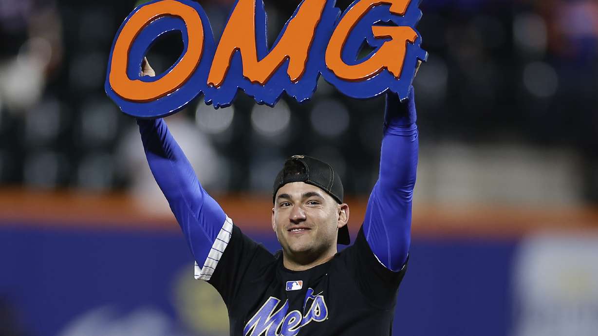 FILE - New York Mets second baseman Jose Iglesias celebrates on the field after the Mets beat the Philadelphia Phillies in Game 4 of the National League baseball playoff series, Oct. 9, 2024, in New York.