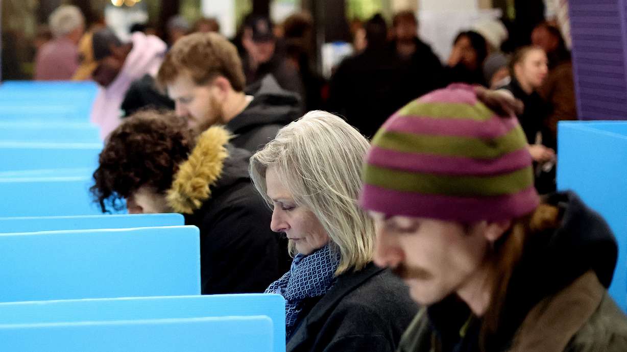 People vote at the Salt Lake City Library on Tuesday. Some Utah House seats appear in play, according to early vote returns, but a big shakeup in the Republican-dominated Legislature isn't in the offing.