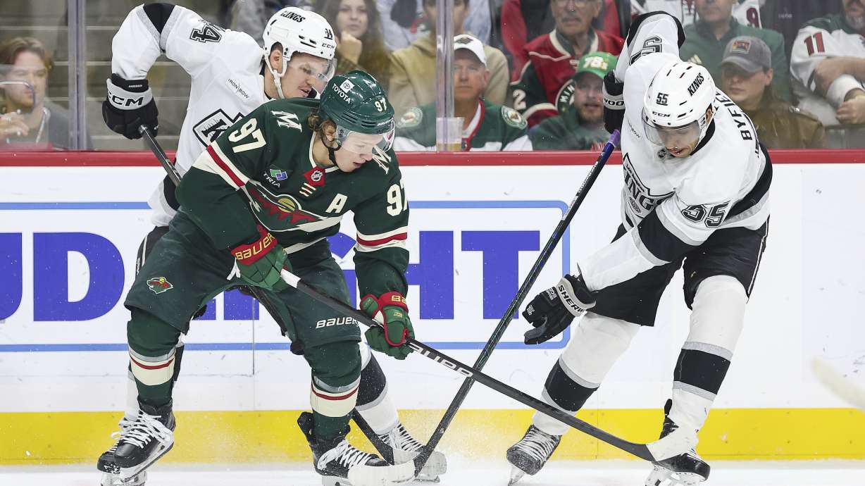Minnesota Wild left wing Kirill Kaprizov, front left, and Los Angeles Kings right wing Quinton Byfield (55) compete for the puck during the first period of an NHL hockey game Tuesday, Nov. 5, 2024, in St. Paul, Minn.