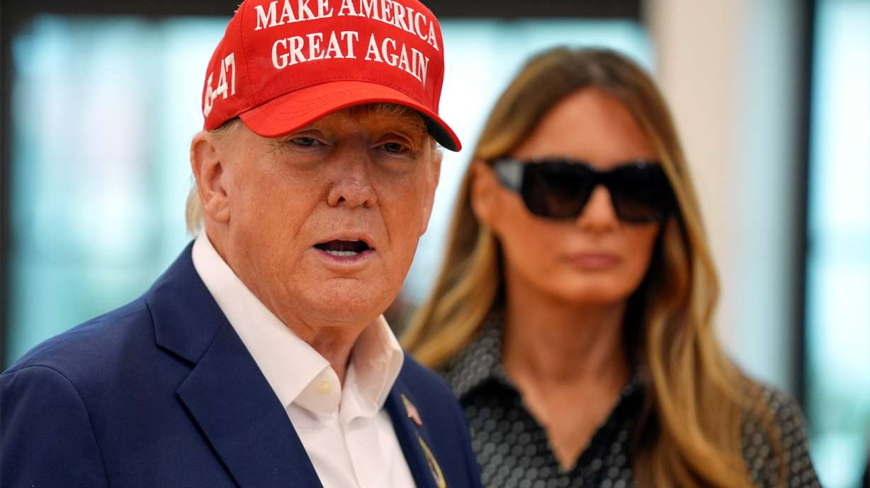 Republican presidential nominee former President Donald Trump speaks as former first lady Melania Trump listens after they voted on Election Day at the Morton and Barbara Mandel Recreation Center, Tuesday, in Palm Beach, Fla.