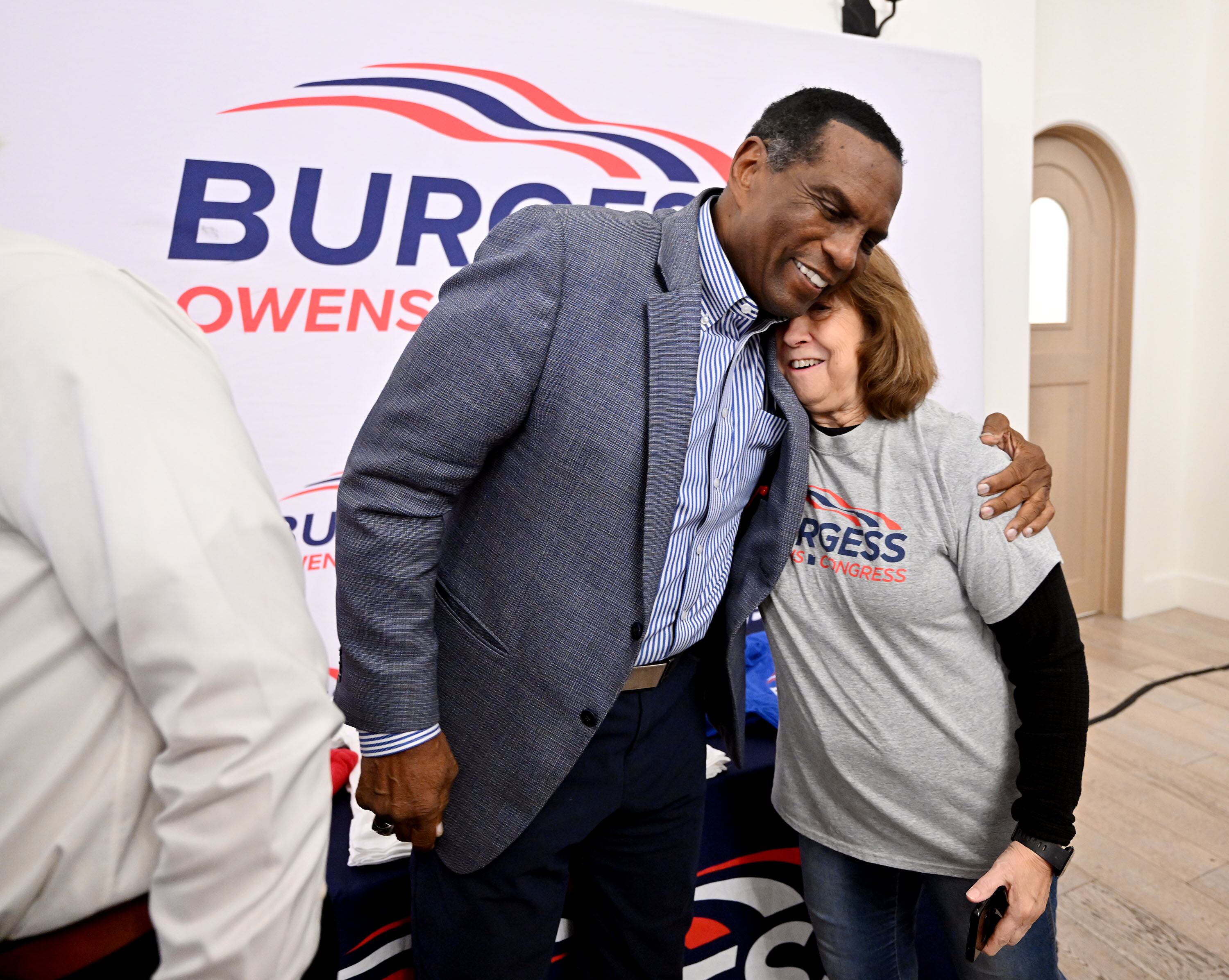 Rep. Burgess Owens, R-Utah, and Lois Wille hug as they talk while at the Utah GOP party in Draper on Tuesday.
