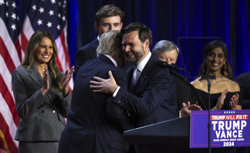 Republican vice presidential nominee JD Vance and Republican presidential nominee and former U.S. President Donald Trump embrace following early results from the 2024 U.S. presidential election in Palm Beach County Convention Center, in West Palm Beach, Florida, Wednesday.