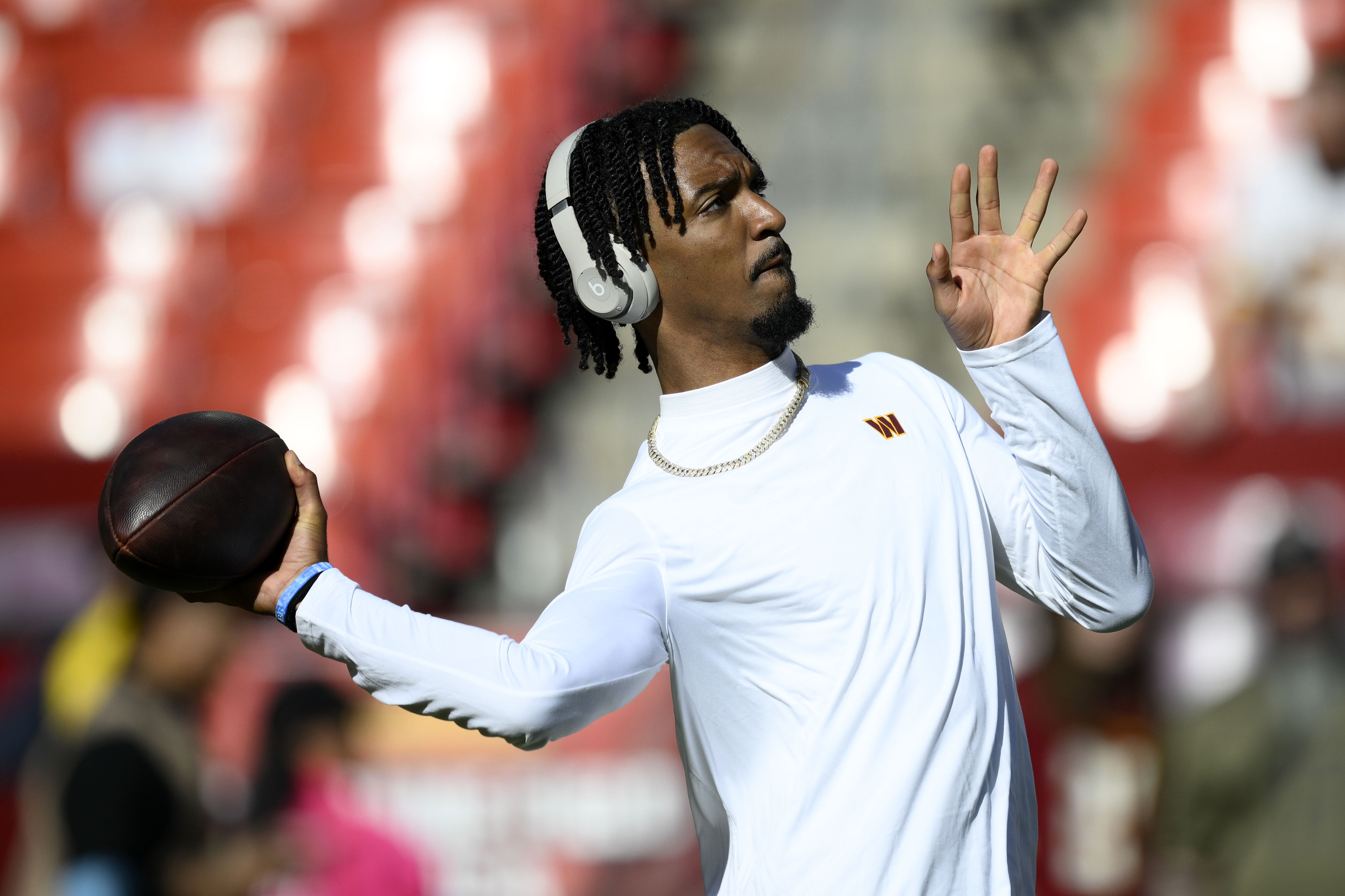 Washington Commanders quarterback Jayden Daniels warms up before an NFL football game against the Carolina Panthers, Sunday, Oct. 20, 2024, in Landover, Md. 