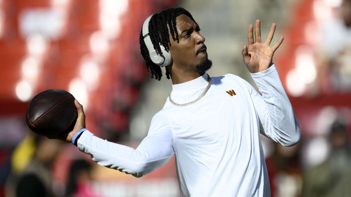 Washington Commanders quarterback Jayden Daniels warms up before an NFL football game against the Carolina Panthers, Sunday, Oct. 20, 2024, in Landover, Md.