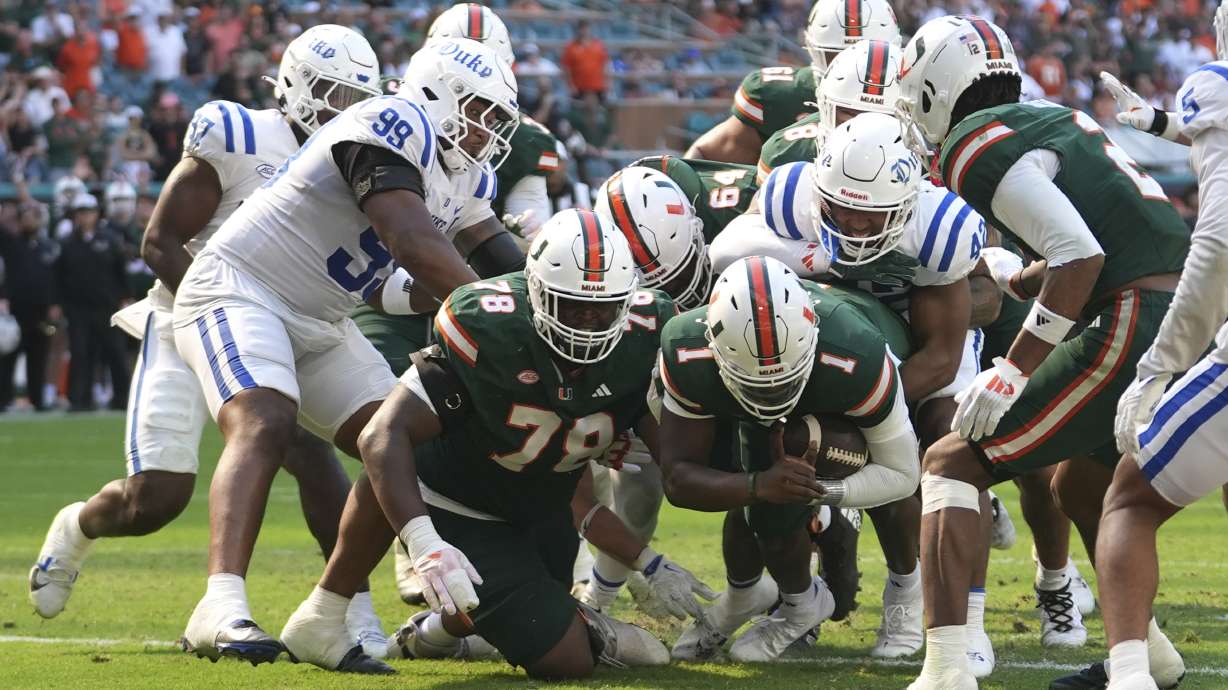 Miami quarterback Cam Ward (1) scores a two-point conversion during the second half of an NCAA college football game against Duke, Saturday, Nov. 2, 2024, in Miami Gardens, Fla.