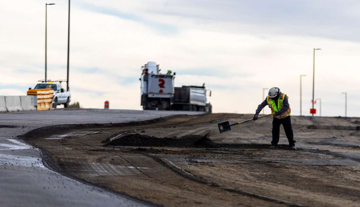 A construction worker works on a major Utah Department of Transportation project in Roy on Monday.