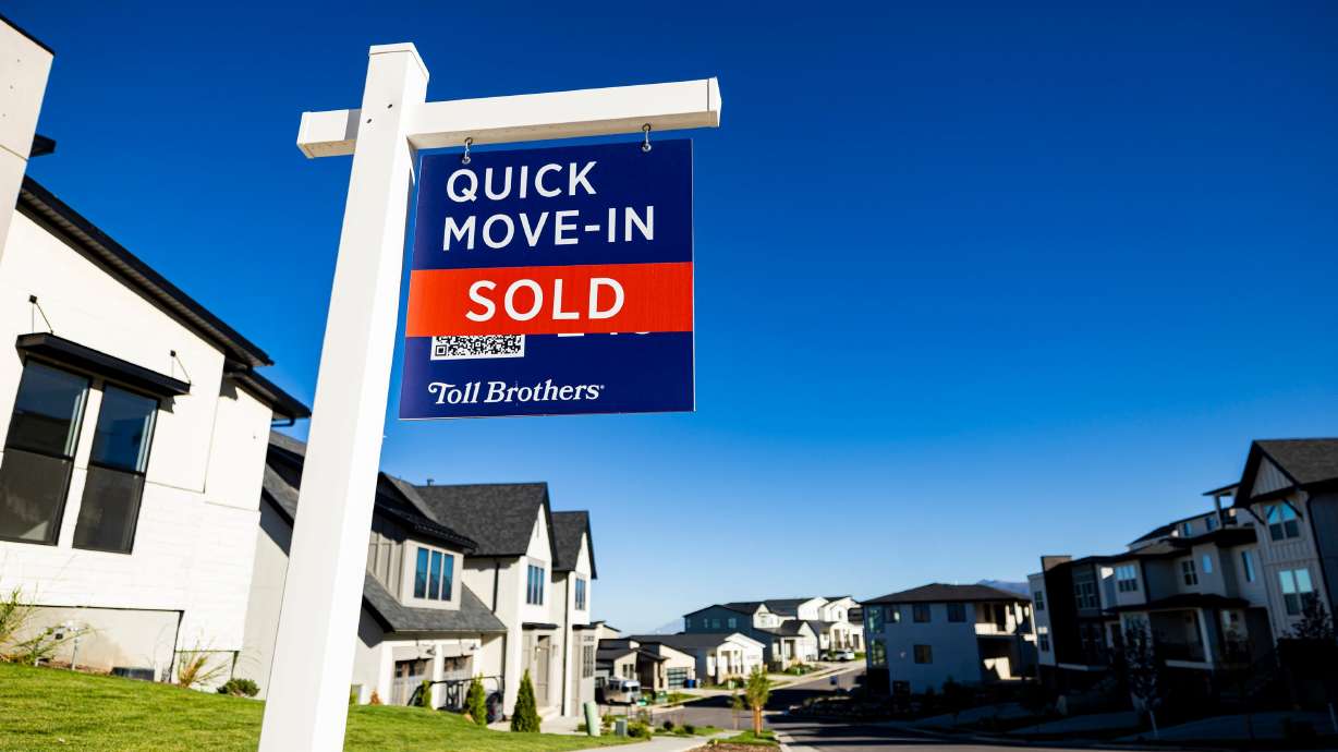 A “For Sale” sign stands among homes in North Salt Lake on Sept. 25. A robust U.S. economy is insulating mortgage rates changes from their usual connection with Federal Reserve adjustments to its benchmark interest rate.