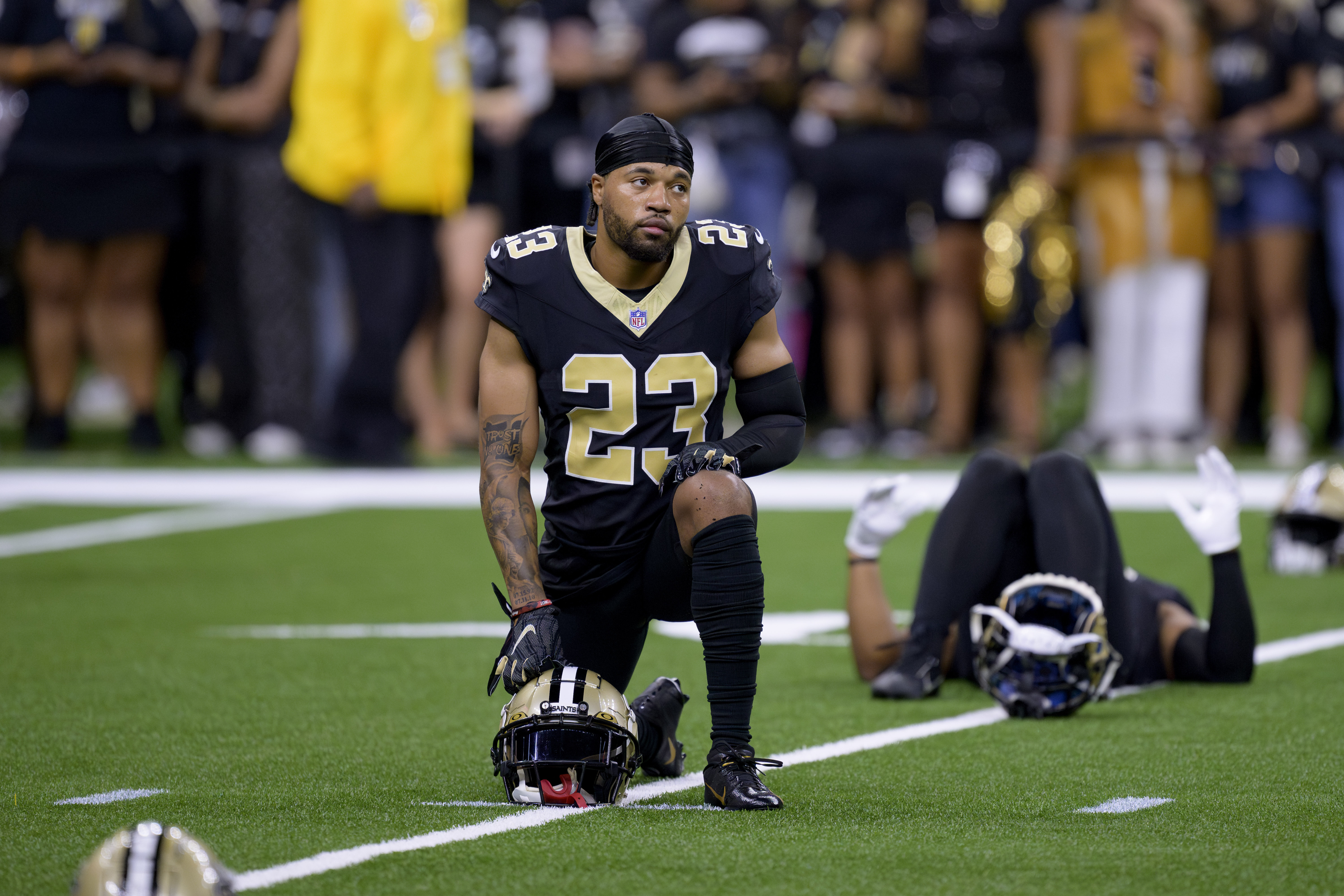 FILE - New Orleans Saints cornerback Marshon Lattimore (23) stretches before an NFL football game against the Carolina Panthers in New Orleans, Sept. 8, 2024.