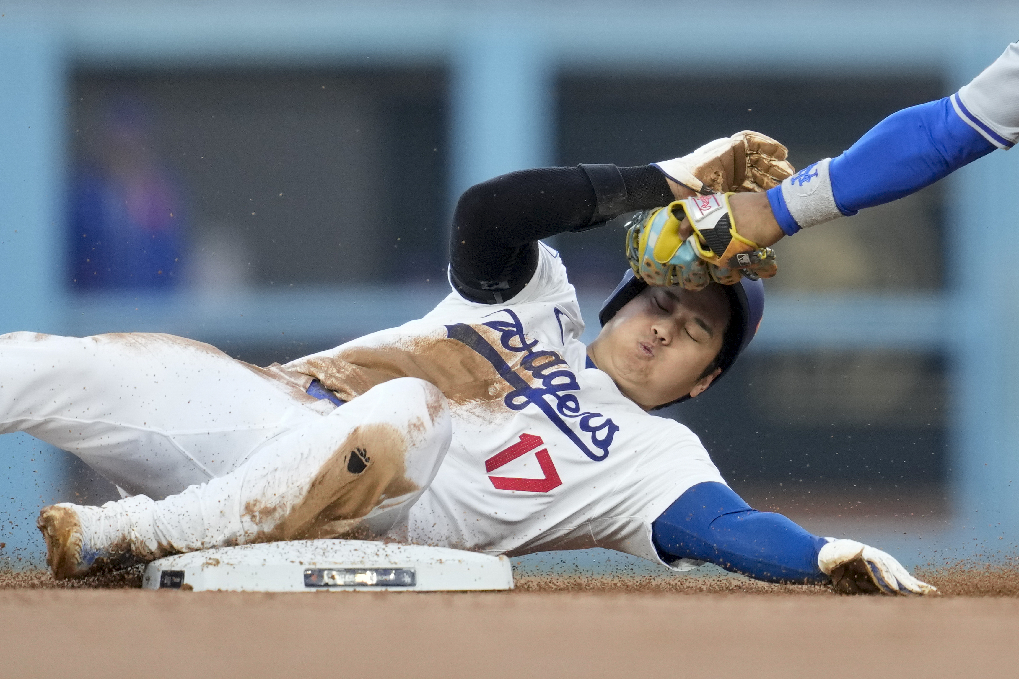 Los Angeles Dodgers' Shohei Ohtani gets caught stealing by New York Mets shortstop Francisco Lindor during the second inning in Game 1 of a baseball NL Championship Series, Sunday, Oct. 13, 2024, in Los Angeles.