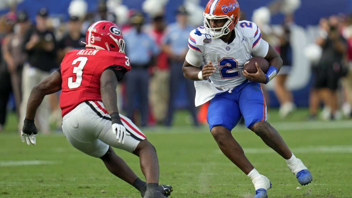 Florida quarterback DJ Lagway (2) looks for a way past Georgia linebacker CJ Allen (3) during the first half of an NCAA college football game, Saturday, Nov. 2, 2024, in Jacksonville, Fla.