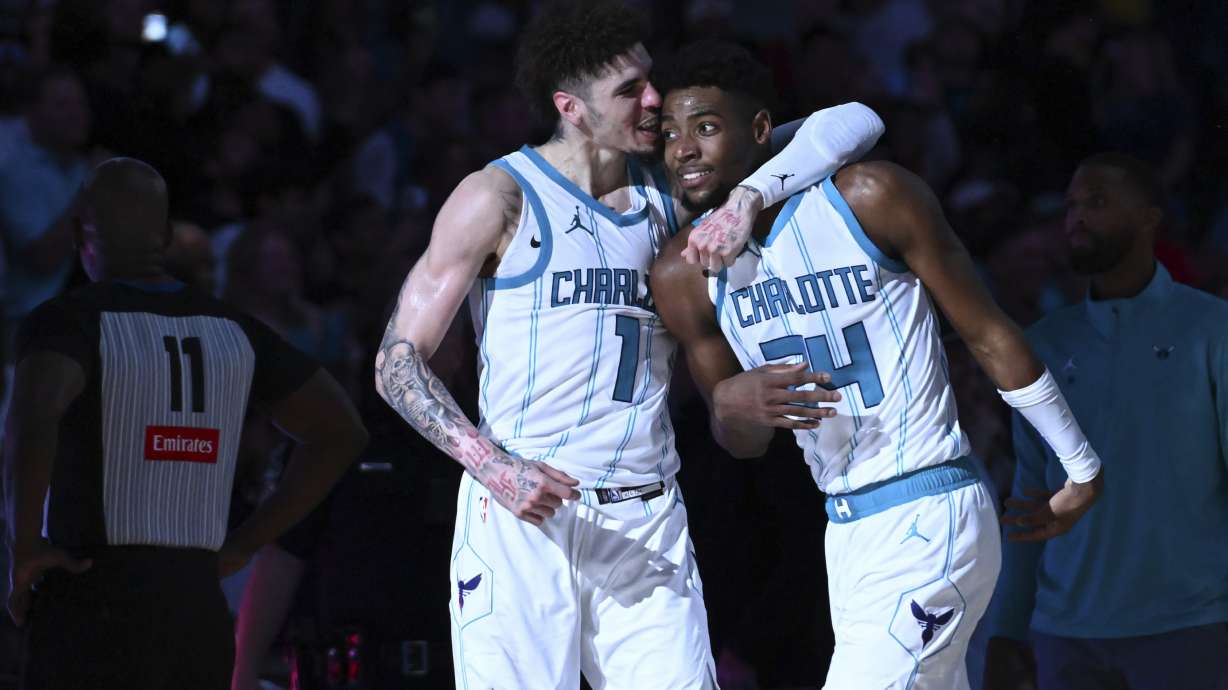 Charlotte Hornets guard LaMelo Ball (1) and forward Brandon Miller (24) embrace after winning an NBA basketball game against the Detroit Pistons, Wednesday, Nov. 6, 2024, in Charlotte, N.C.