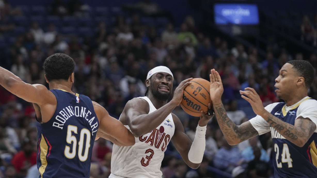 Cleveland Cavaliers guard Caris LeVert (3) battles between New Orleans Pelicans forward Jeremiah Robinson-Earl (50) and guard Jordan Hawkins (24) in the first half of an NBA basketball game in New Orleans, Wednesday, Nov. 6, 2024.