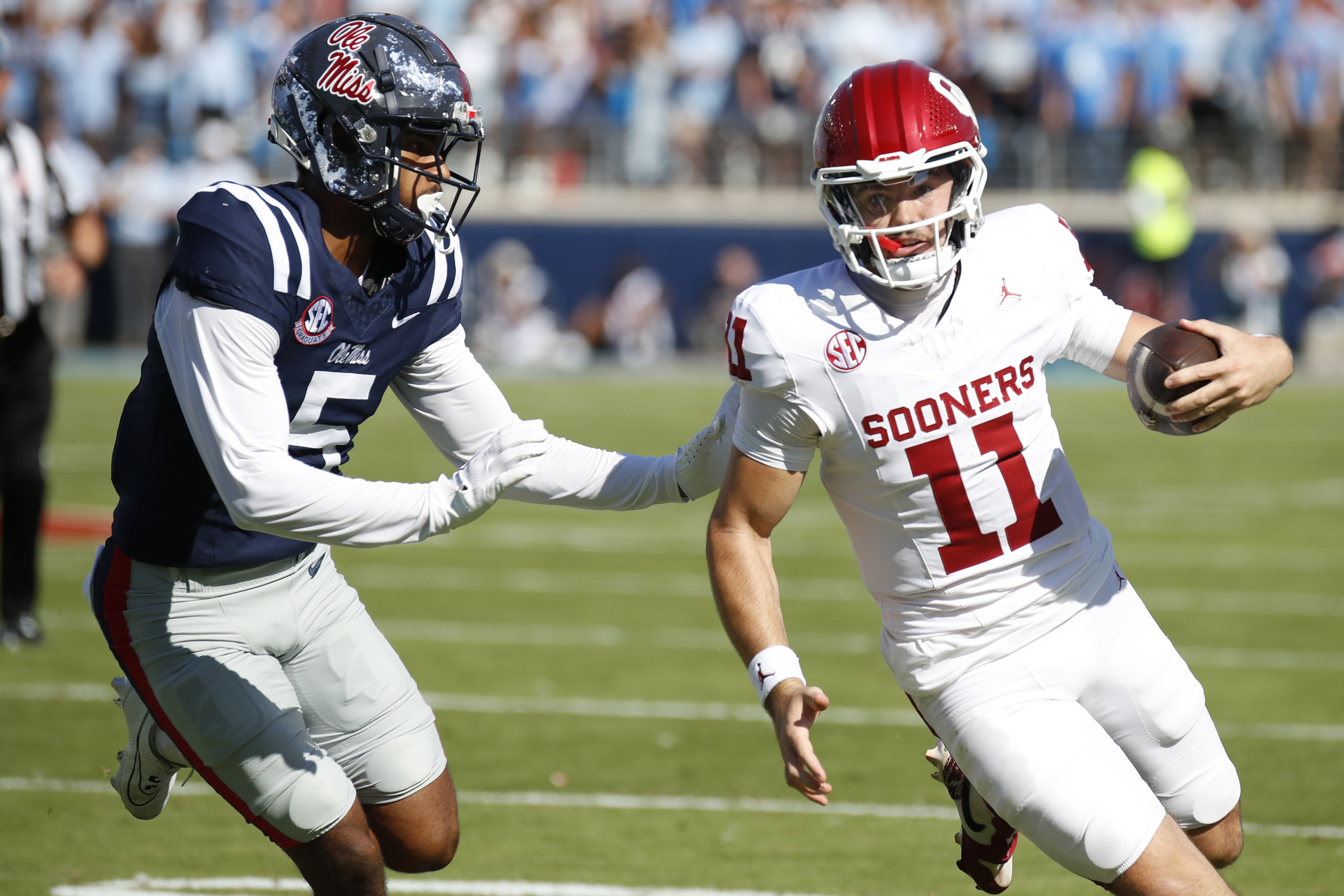 Oklahoma quarterback Jackson Arnold (11) tries to get around Mississippi strong safety John Saunders Jr. (5) during the first half of an NCAA college football game Saturday, Oct. 26, 2024, in Oxford, Miss.