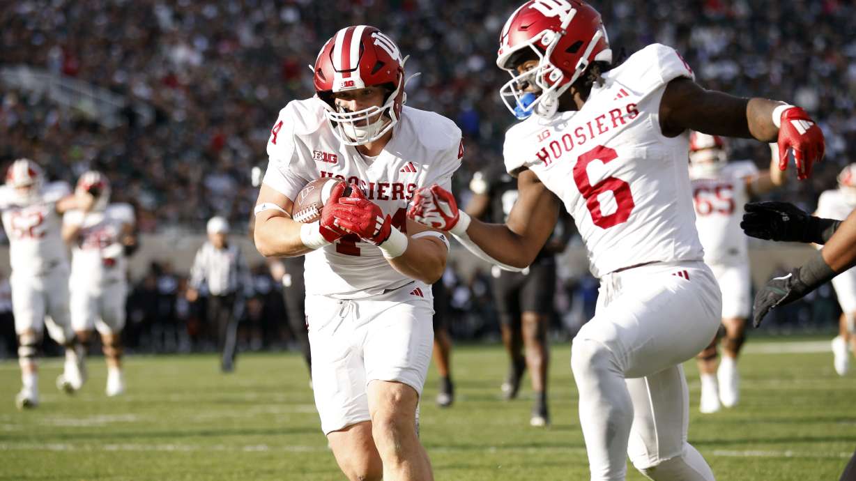 Indiana tight end Zach Horton, left, scores on a pass reception as Indiana running back Justice Ellison (6) looks on during the first half of an NCAA college football game against Michigan State, Saturday, Nov. 2, 2024, in East Lansing, Mich.