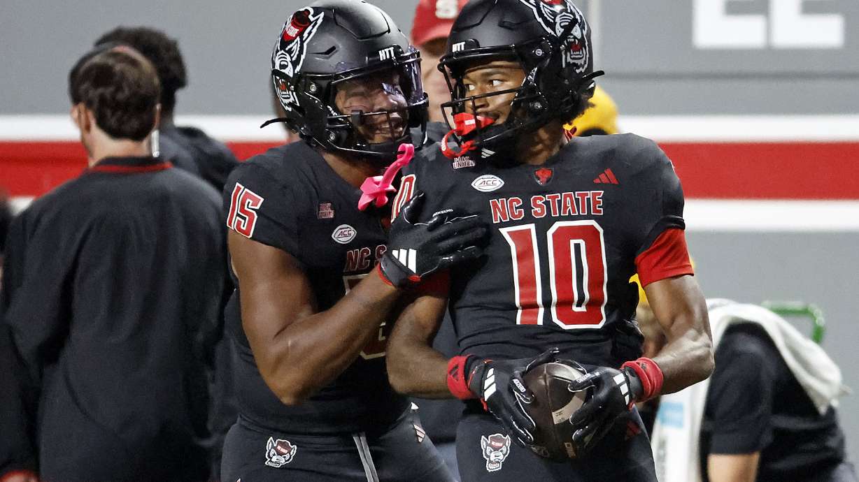 North Carolina State wide receiver Kevin Concepcion (10) is congratulated on a catch by teammate Justin Joly (15) during the first half of an NCAA college football game against Syracuse in Raleigh, N.C., Saturday, Oct. 12, 2024.