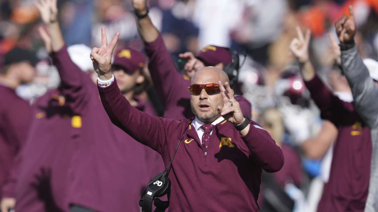 Minnesota head coach P.J. Fleck calls for a two-point conversion after a touchdown late in the second half of an NCAA college football game against Illinois on Saturday, Nov. 2, 2024, in Champaign, Ill.