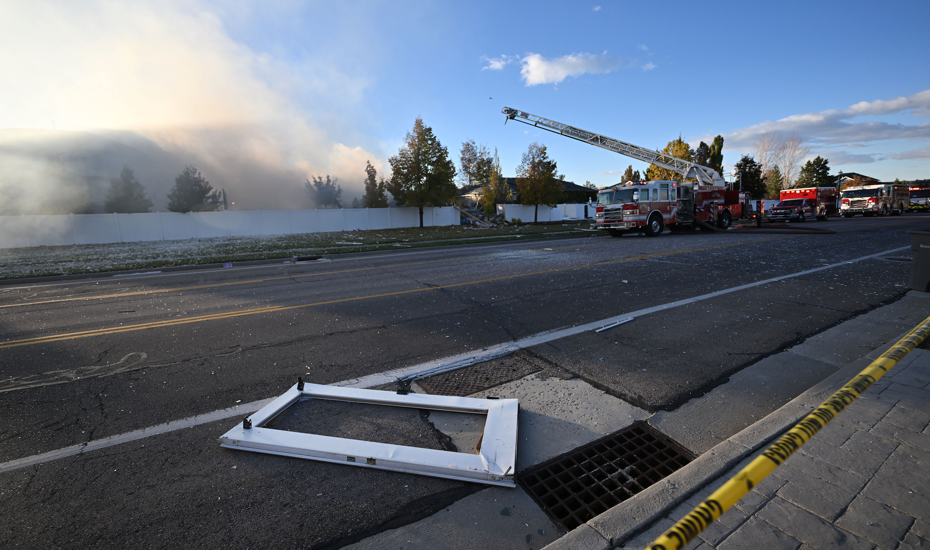 A back door from the home lays in the street behind the home as firefighters respond to an explosion at a home in South Jordan on Wednesday.