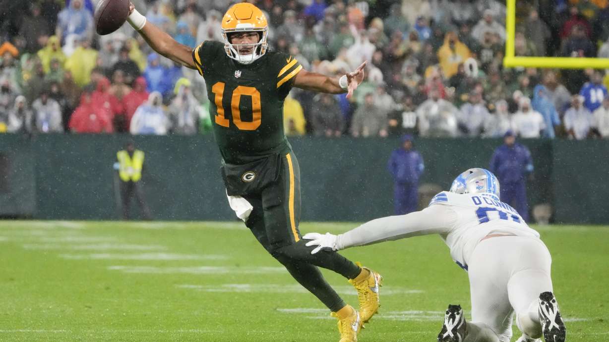 Green Bay Packers quarterback Jordan Love (10) runs around Detroit Lions defensive end Pat O'Connor (95) during the second half of an NFL football game Sunday, Nov. 3, 2024, in Green Bay, Wis.