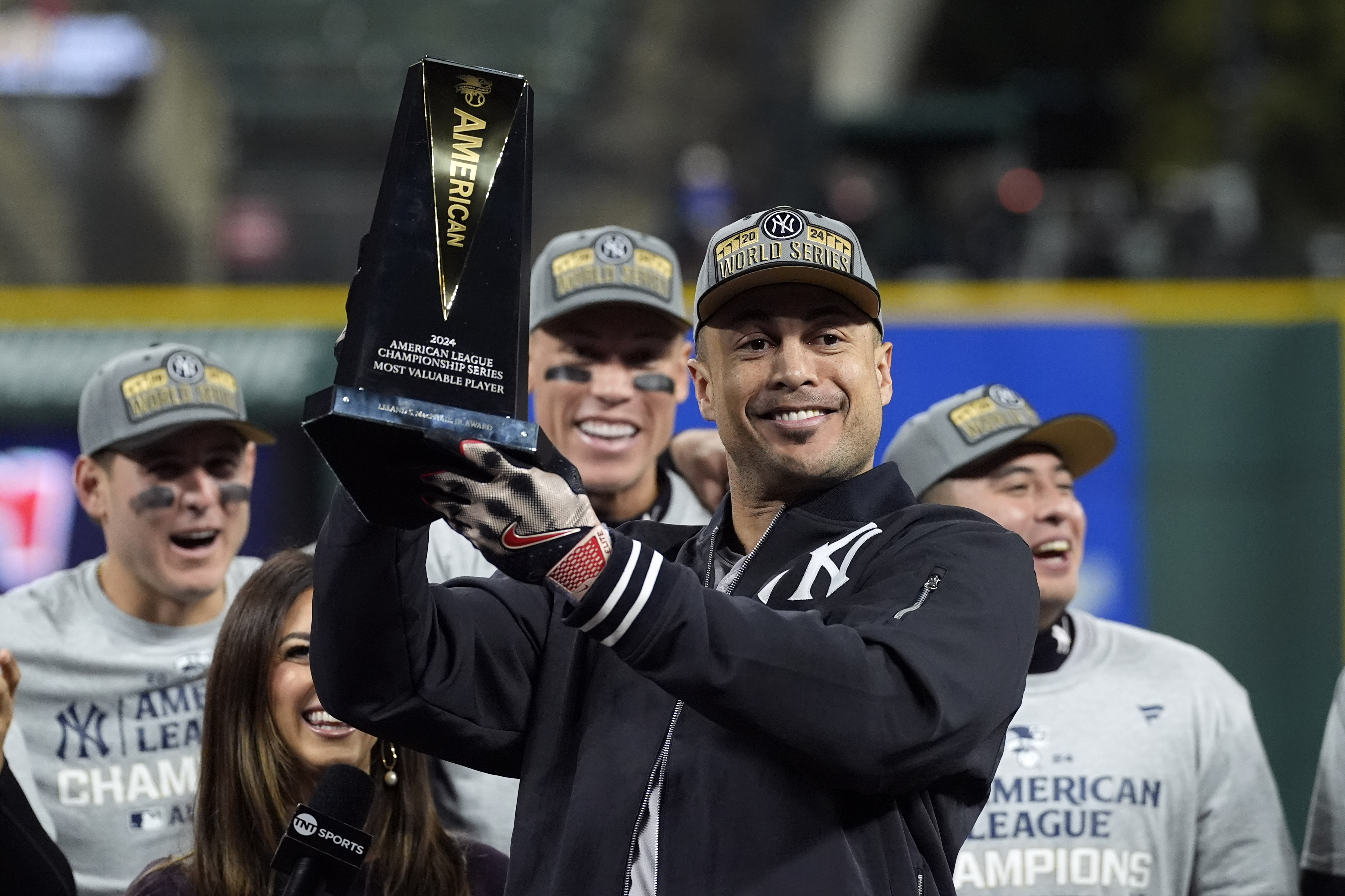 New York Yankees' Giancarlo Stanton holds up the MVP trophy after Game 5 of the baseball AL Championship Series Sunday, Oct. 20, 2024, in Cleveland. The Yankees won 5-2 to advance to the World Series.