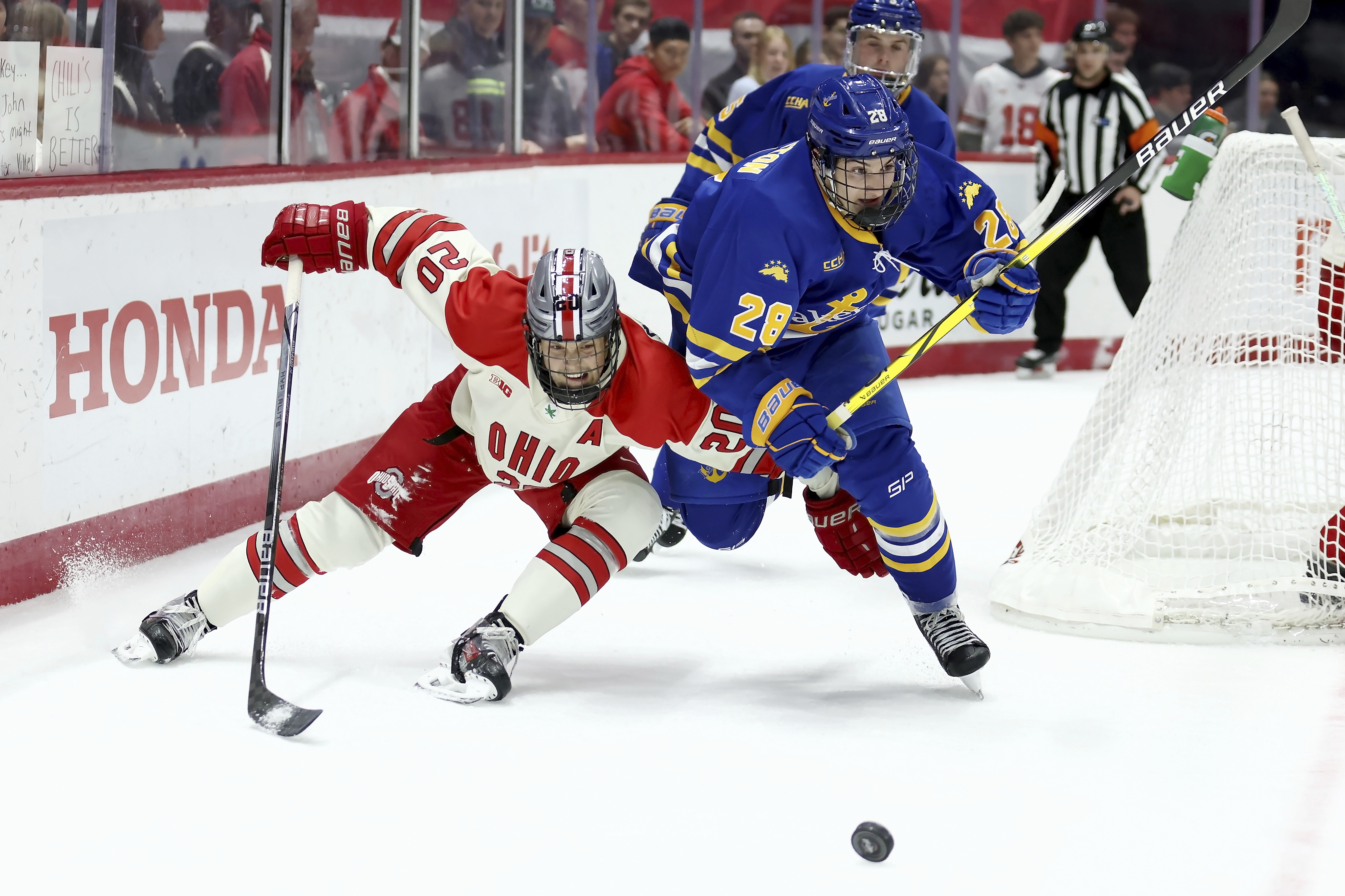 FILE - Ohio St. forward Aiden Hansen-Bukata (20) and Lake Superior St. forward John Herrington (28) skate after the puck during an NCAA hockey game on Nov. 2, 2024, in Columbus, Ohio.