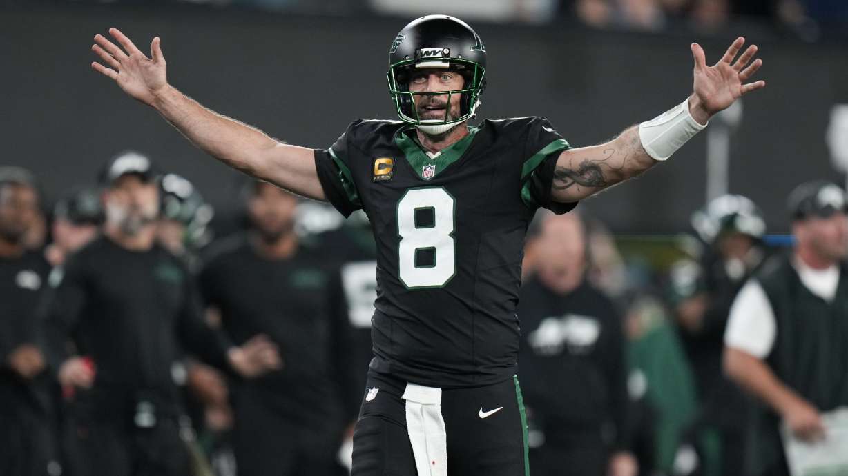 New York Jets quarterback Aaron Rodgers (8) celebrates as officials review a catch by wide receiver Garrett Wilson during the second half of an NFL football game against the Houston Texans, Thursday, Oct. 31, 2024, in East Rutherford, N.J.
