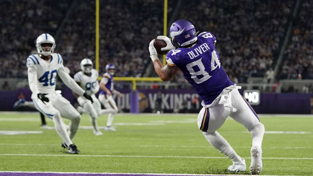Minnesota Vikings tight end Josh Oliver (84) catches a 14-yard touchdown pass during the second half of an NFL football game against the Indianapolis Colts, Sunday, Nov. 3, 2024, in Minneapolis.