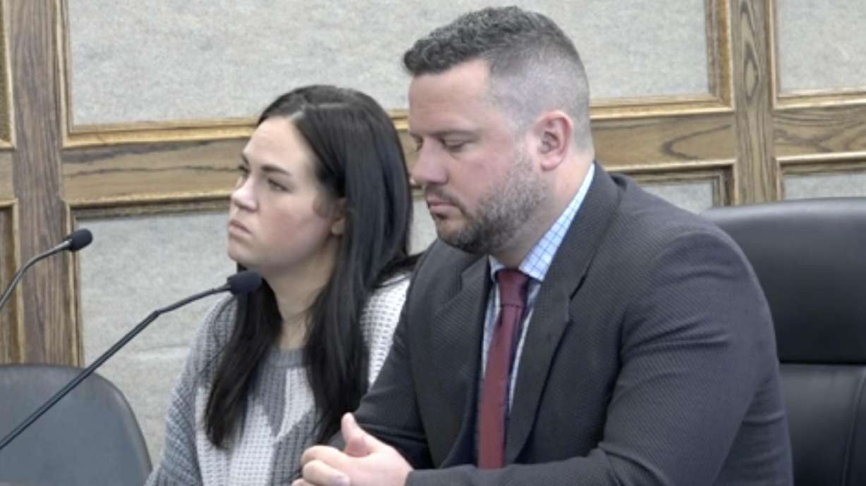 Kaitlyn Fisher, left, and her defense attorney, John Malek, attends her sentencing for charges related to embezzlement on Wednesday in Idaho Falls, Idaho.
