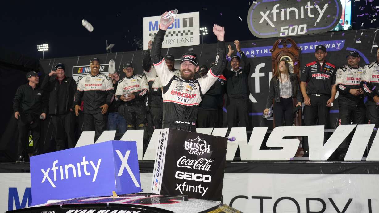 Ryan Blaney, center, celebrates in Victory Lane after winning a NASCAR Cup Series auto race at Martinsville Speedway in Martinsville, Va., Sunday, Nov. 3, 2024.
