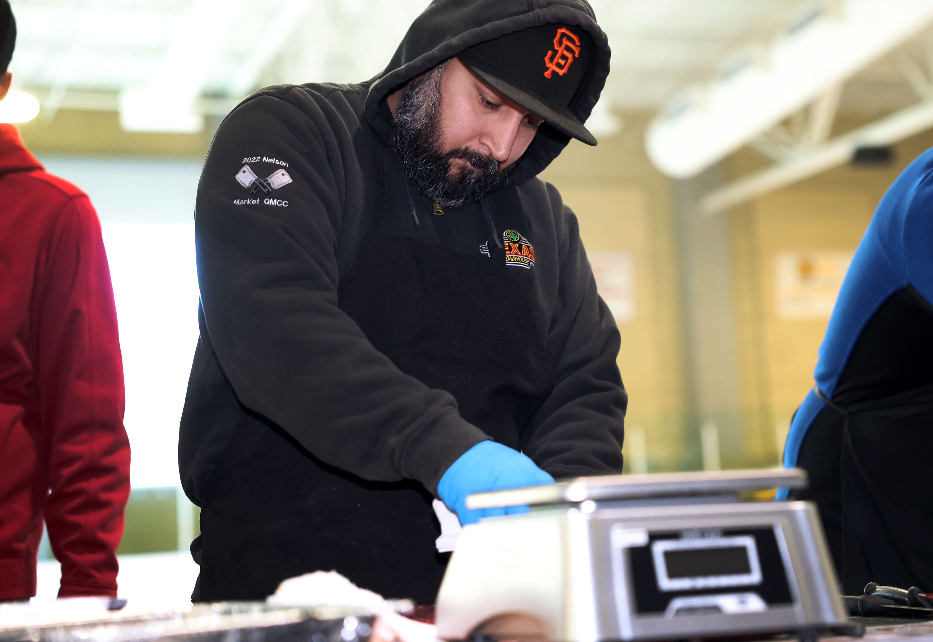 Texas Roadhouse meat cutter José Landa competes in the Meat Cutting on Ice competition at the South Davis Recreation Center in Bountiful on Thursday. Meat cutters are judged on quality and yield in this timed cut-off.
