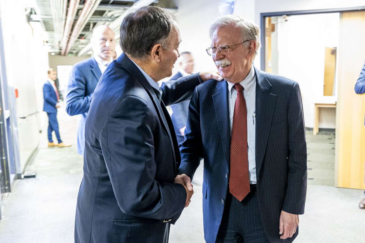 Former U.S. national security adviser John Bolton shakes hands with former Utah Gov. Gary Herbert during the Utah Valley Growth and Prosperity Summit held at the Sorensen Student Center Grand Ballroom on the campus of Utah Valley University in Orem on Thursday.