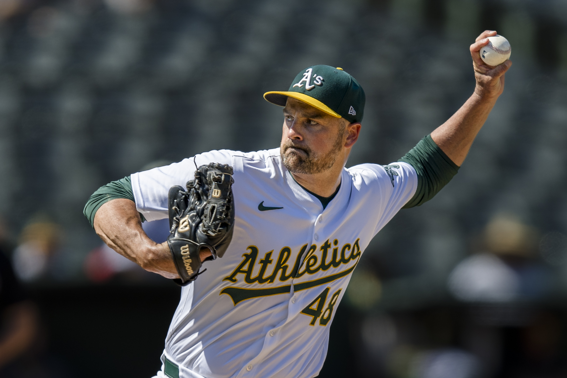 FILE - Oakland Athletics closing pitcher T.J. McFarland throws against the Baltimore Orioles during the ninth inning of a baseball game Saturday, July 6, 2024, in Oakland, Calif. Left-hander T.J. McFarland is remaining with the Athletics, agreeing Thursday, Nov. 7, 2025 to a $1.8 million, one-year contract.