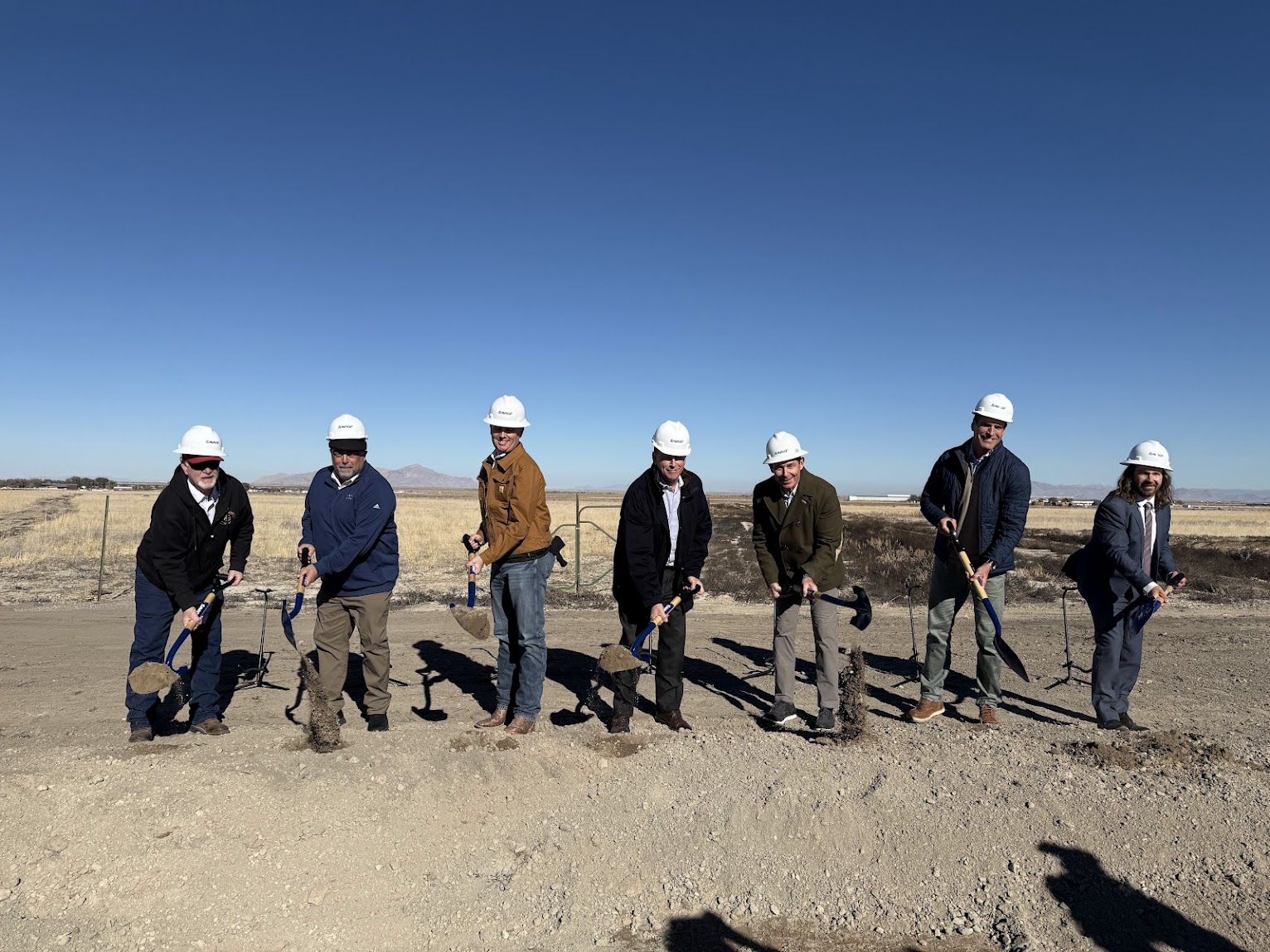 Pictured left to right are Grantsville City Mayor Neil Critchlow, Tooele County Council Chair Jared Hamner, Utah Gov. Spencer Cox, Savage CEO Kirk Aubry, U.S. Senator-elect John Curtis, The Romney Group President and CEO Josh Romney, and Utah Rep. Tim Jimenez in Grantsville on Thursday, at the groundbreaking for a new railroad in Tooele County.