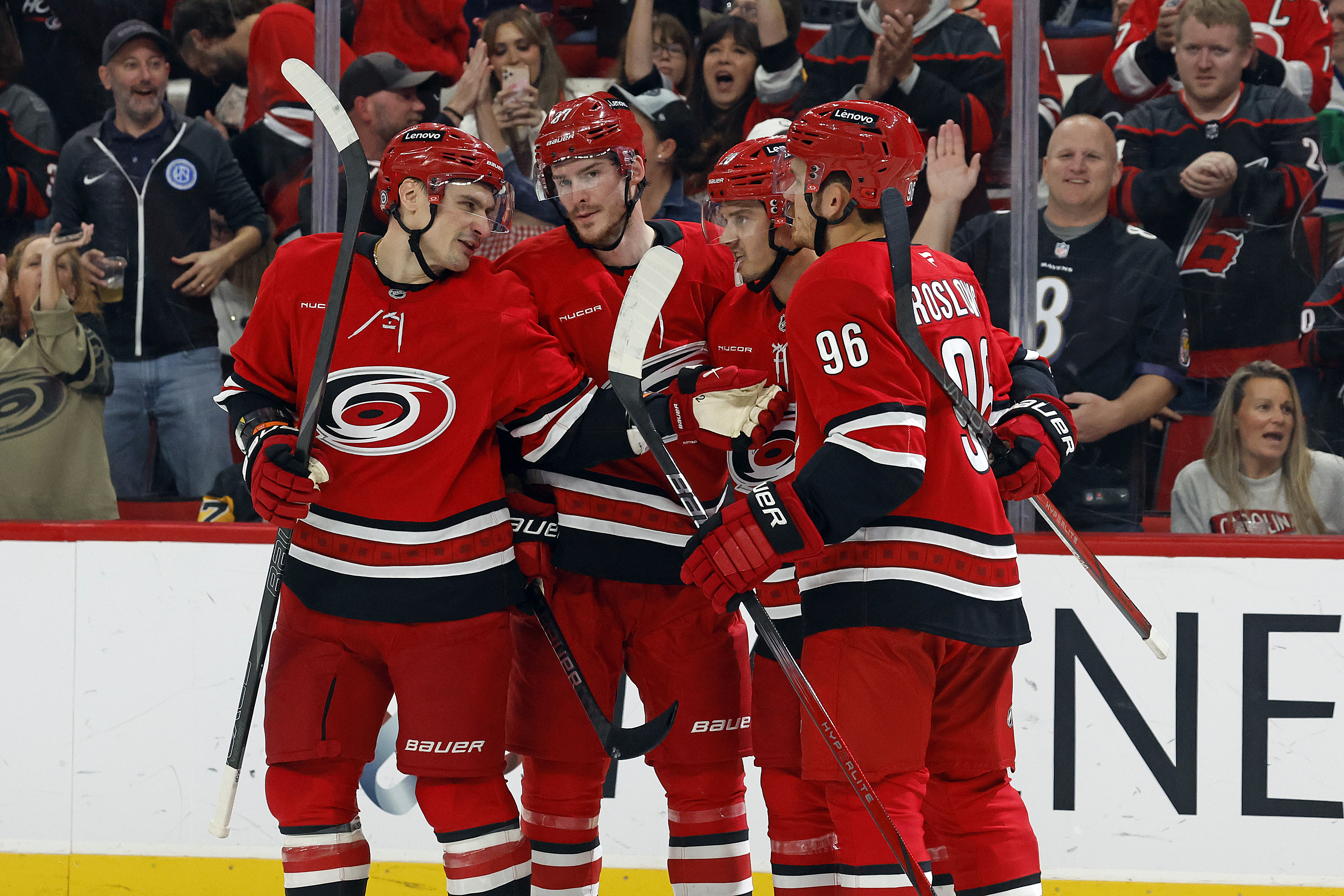 Carolina Hurricanes' Jack Roslovic (96) celebrates his goal with teammates Dmitry Orlov, left, Andrei Svechnikov, second left, and Sebastian Aho (20) during the second period of an NHL hockey game in Raleigh, N.C., Thursday, Nov. 7, 2024.