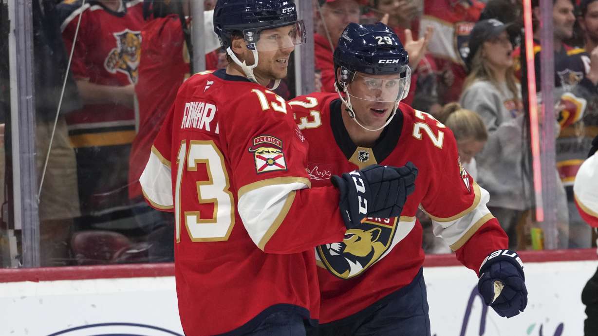 Florida Panthers center Carter Verhaeghe (23) is congratulated by center Sam Reinhart (13) after scoring a goal during the second period of an NHL hockey game against the Nashville Predators, Thursday, Nov. 7, 2024, in Sunrise, Fla.